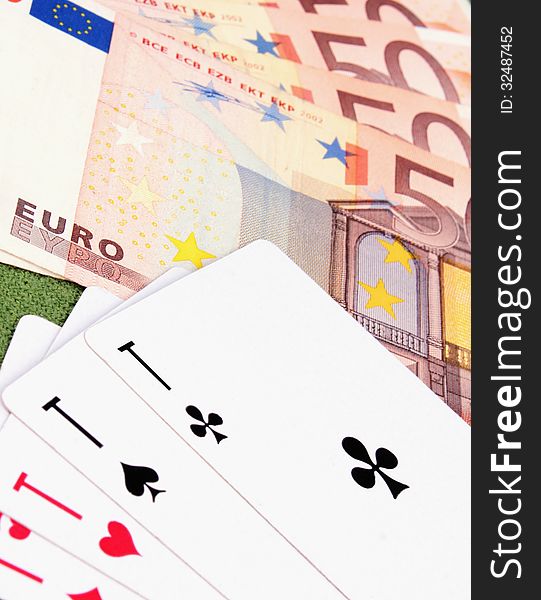 Cards and money as a symbol of gambling in casino (details). Cards and money as a symbol of gambling in casino (details)