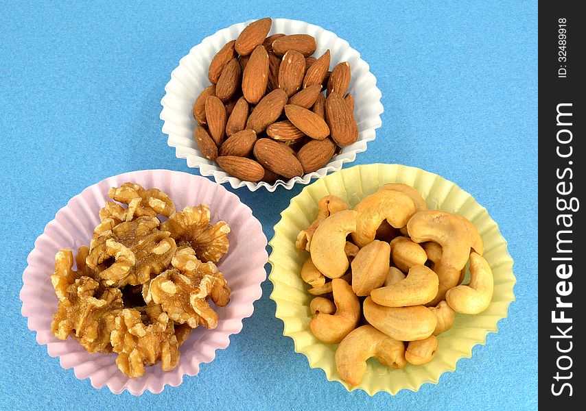 Cashews, almonds and walnuts in paper cups. Cashews, almonds and walnuts in paper cups.