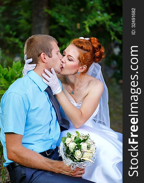 Passionate Wedding Kiss in a Summer City Park