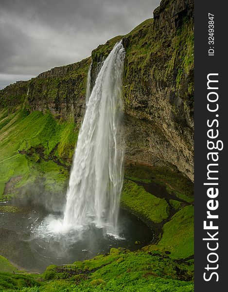 Well-known Seljalandsfoss waterfall on the south coast of the Iceland. Well-known Seljalandsfoss waterfall on the south coast of the Iceland.