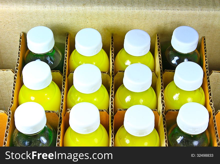 Food coloring bottles in a cardboard box