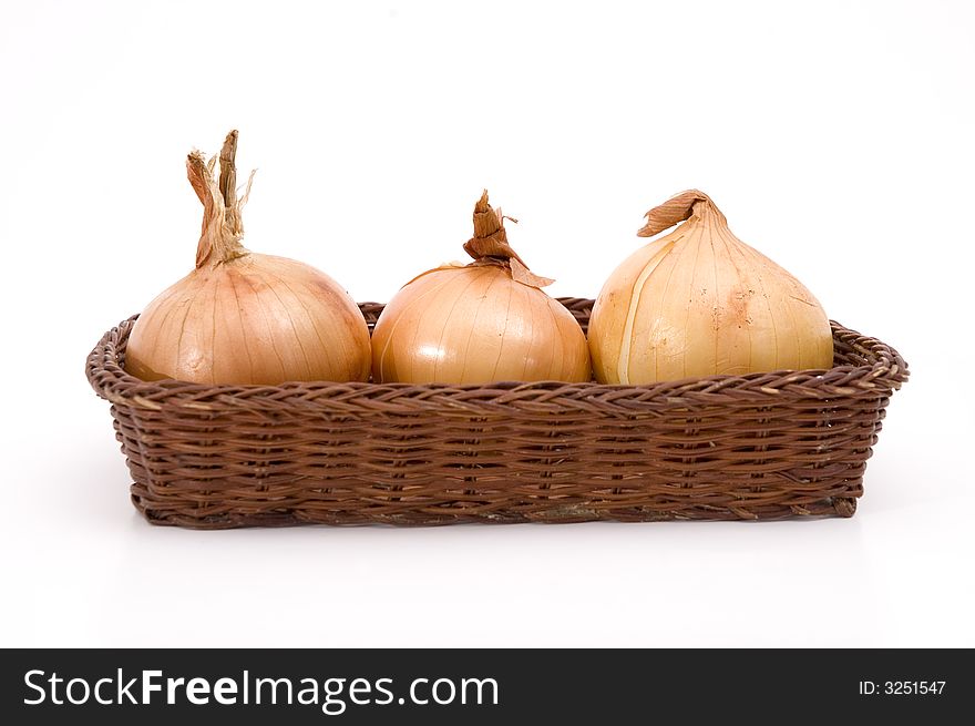 Group of 3 white onions on a basket isolated over white. Group of 3 white onions on a basket isolated over white