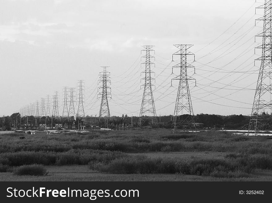 Power lines disappearing into the horizon. Black and white photo.