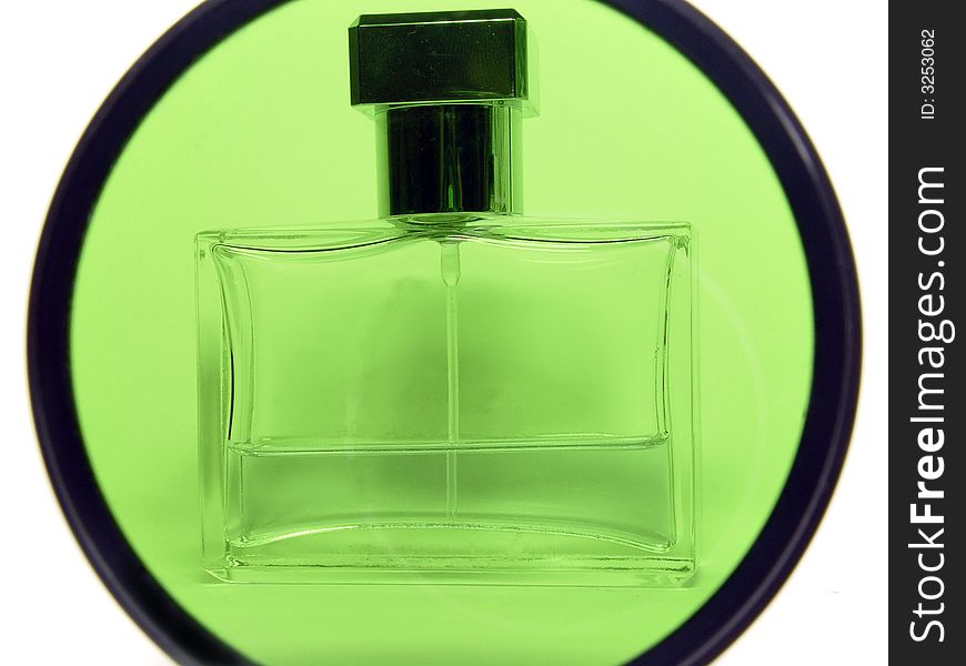 Container with perfum stands up for glass of the green photofilter