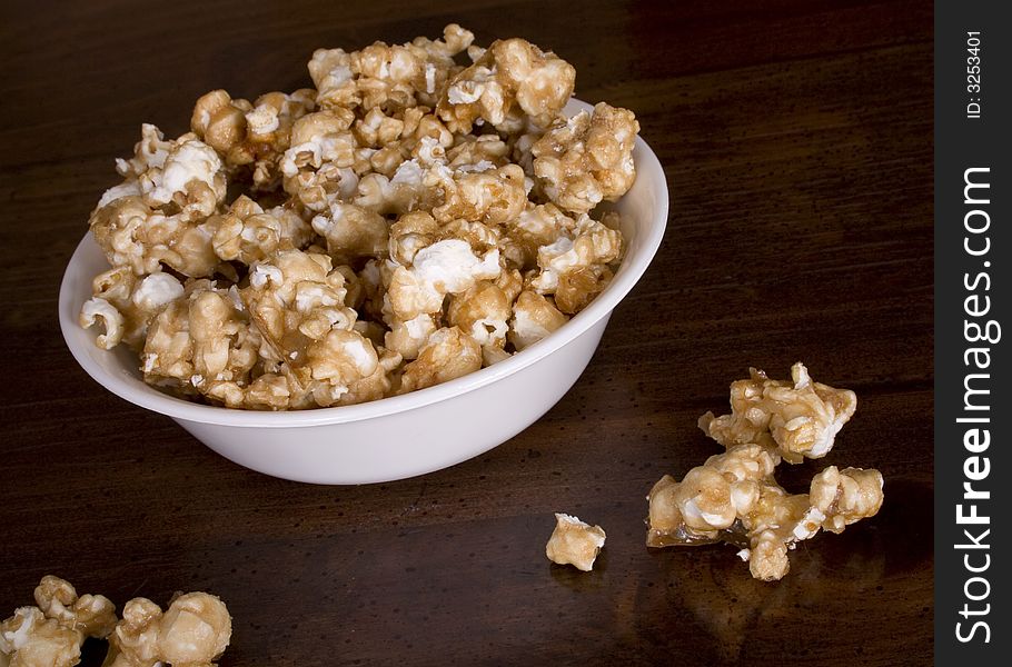 A snack sized bowl filled with carmel corn. A snack sized bowl filled with carmel corn.