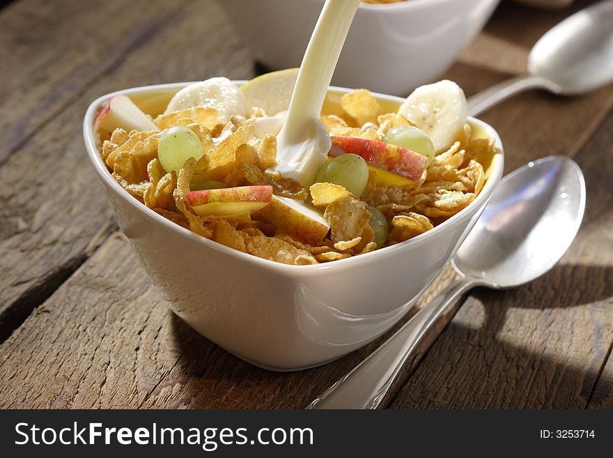 Corn flakes with slices of apples, grapes and bananas. Corn flakes with slices of apples, grapes and bananas