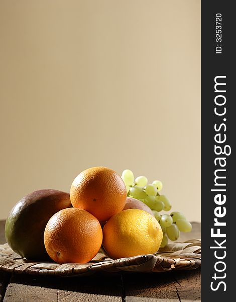 Stilllife with oranges, lemon, grapes, apple and mango. Stilllife with oranges, lemon, grapes, apple and mango