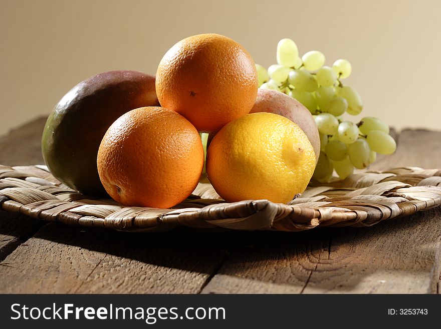 Stilllife with oranges, lemon, grapes, apple and mango. Stilllife with oranges, lemon, grapes, apple and mango