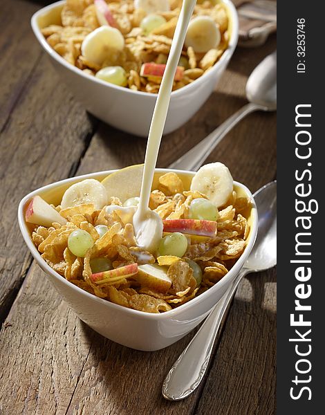 Corn flakes with slices of apples, grapes and bananas. Corn flakes with slices of apples, grapes and bananas