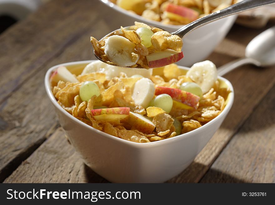 Corn flakes with slices of apples, grapes and bananas. Corn flakes with slices of apples, grapes and bananas