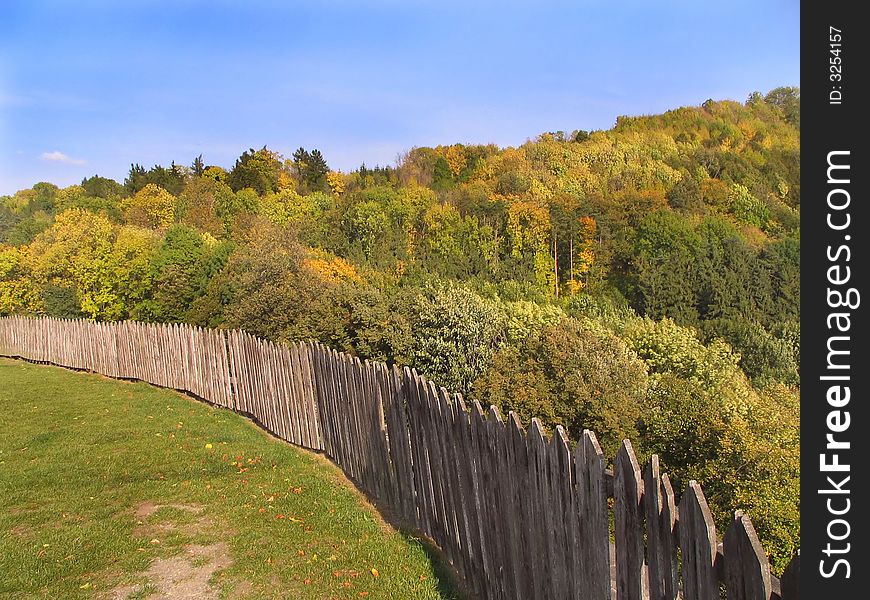 Long wood railing along the house