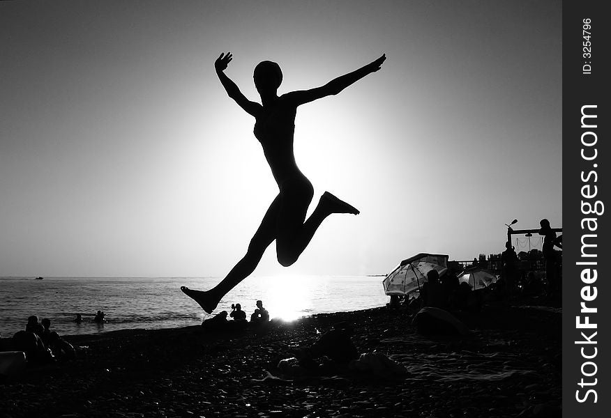 Leap over the girl evening beach. Leap over the girl evening beach
