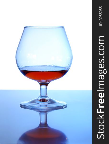 Glass with cognac on white background. Glass with cognac on white background