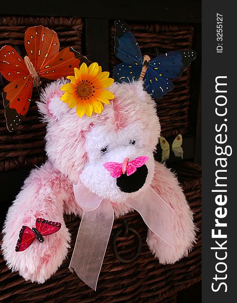 Pink Teddy Bear surrounded by flowers and butterflies. Pink Teddy Bear surrounded by flowers and butterflies