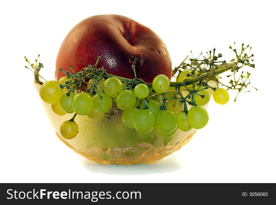 Bowl filled with bunch of grapes and peach. Bowl filled with bunch of grapes and peach