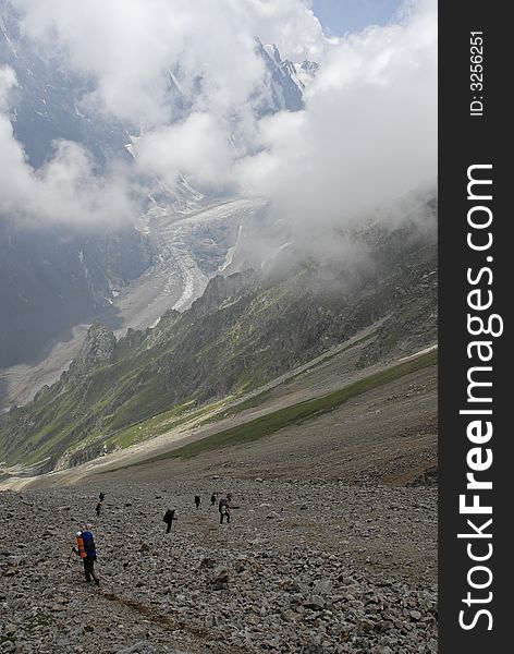 Group of people trekking  down on mountain