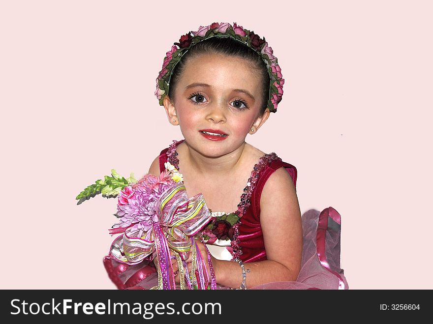 Beautiful little ballerina holding a bouquet presented to her for a job well done. Beautiful little ballerina holding a bouquet presented to her for a job well done.