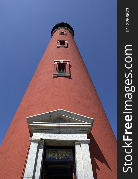 Low angle view of Ponce Inlet lighthouse with blue sky background, Florida, U.S.A.
