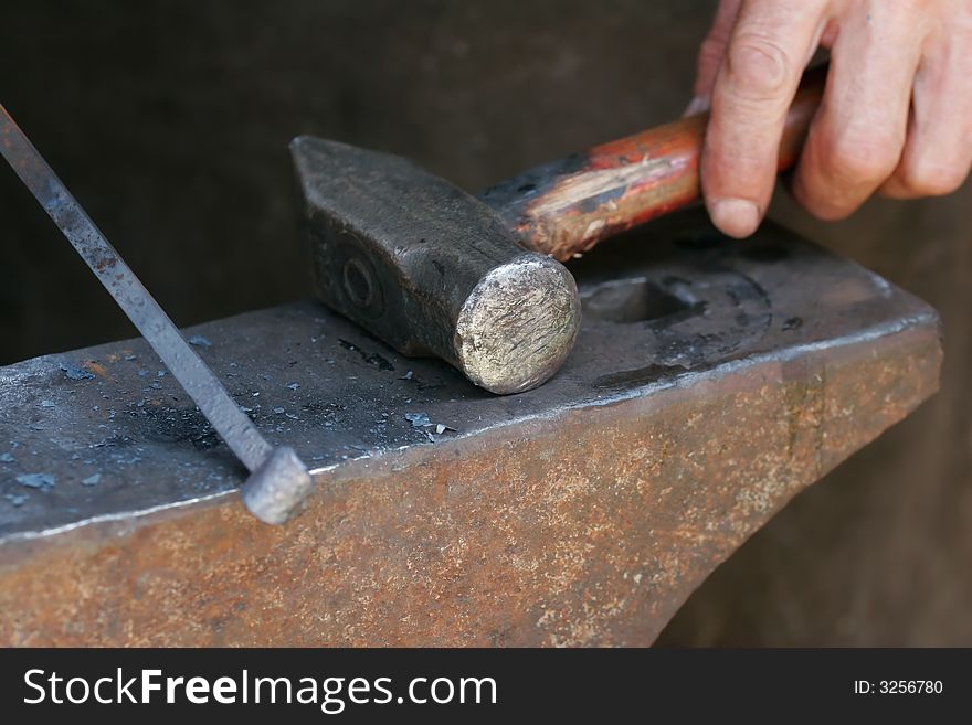 A balcksmith handling his hammer and iron rod. A balcksmith handling his hammer and iron rod.