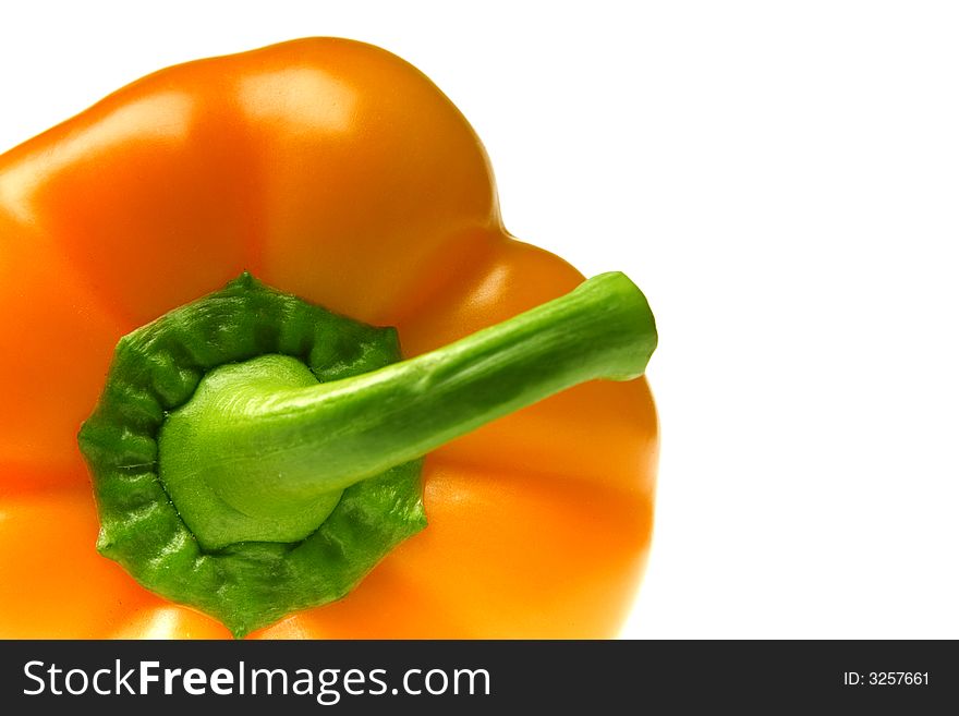 Excellent orange pepper with a green pod on a white background