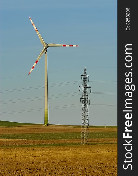 Windmill and power pole on the horizon. Windmill and power pole on the horizon