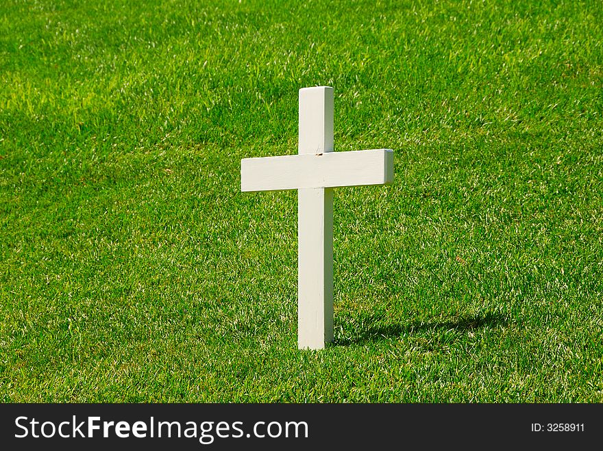 White Cross with a green grassy background.