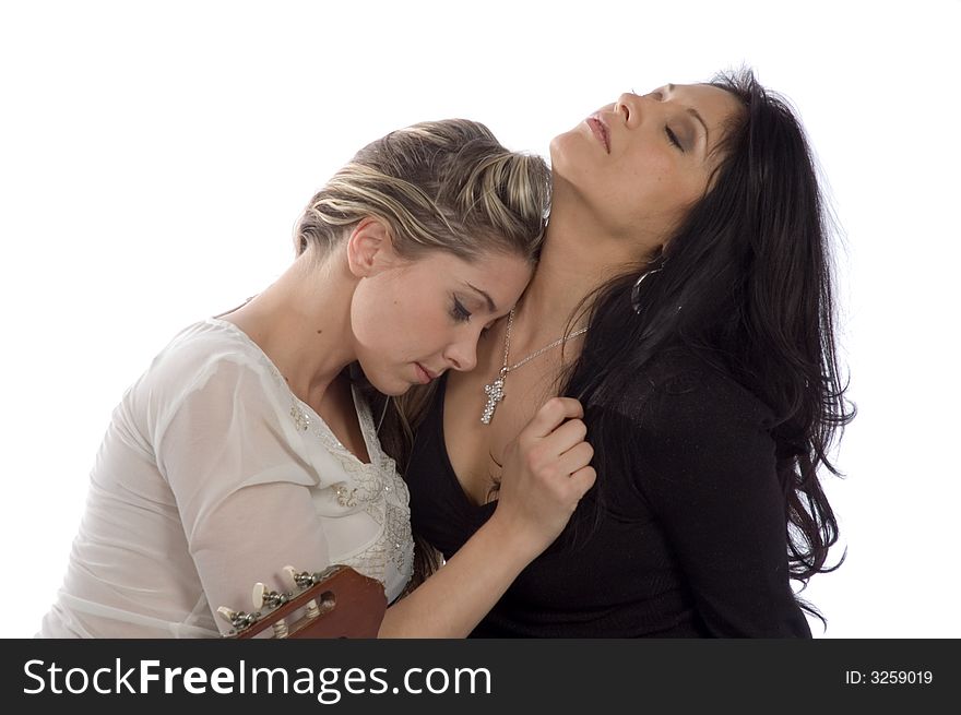 Hispanic woman sharing a tender moment with caucasian girl freind isolated over white. Hispanic woman sharing a tender moment with caucasian girl freind isolated over white