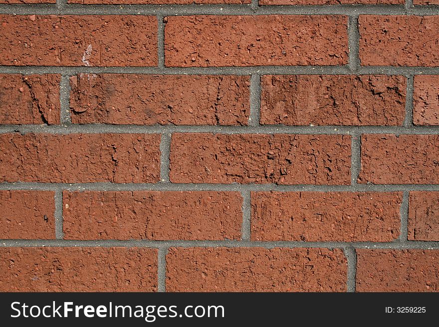 Red brick wall in the sun light, with gray mortar. Red brick wall in the sun light, with gray mortar