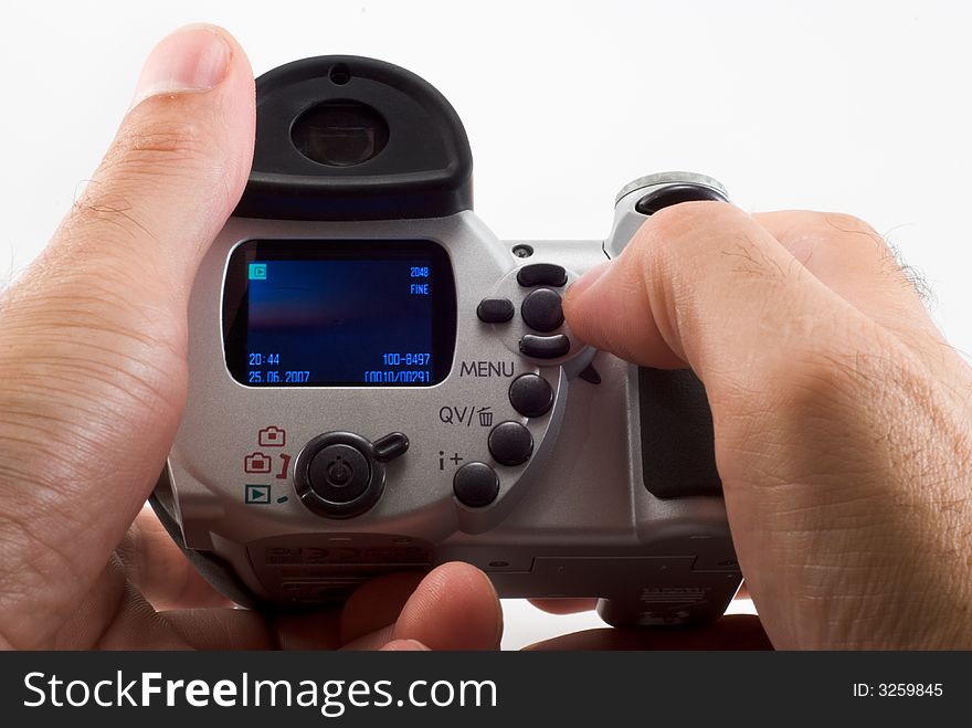 The man holds the digital camera, a close up. The man holds the digital camera, a close up.