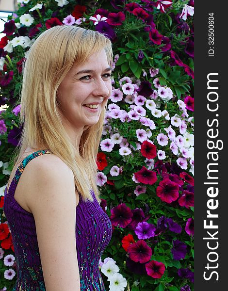 Smiling girl on the background of garden flowers. Smiling girl on the background of garden flowers