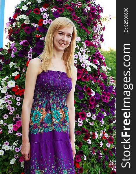 Smiling girl on the background of garden flowers. Smiling girl on the background of garden flowers