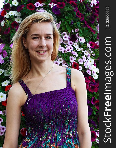 Smiling girl on the background of garden flowers. Smiling girl on the background of garden flowers