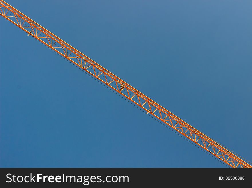 The steel structure, truss of a crane over blue sky. The steel structure, truss of a crane over blue sky