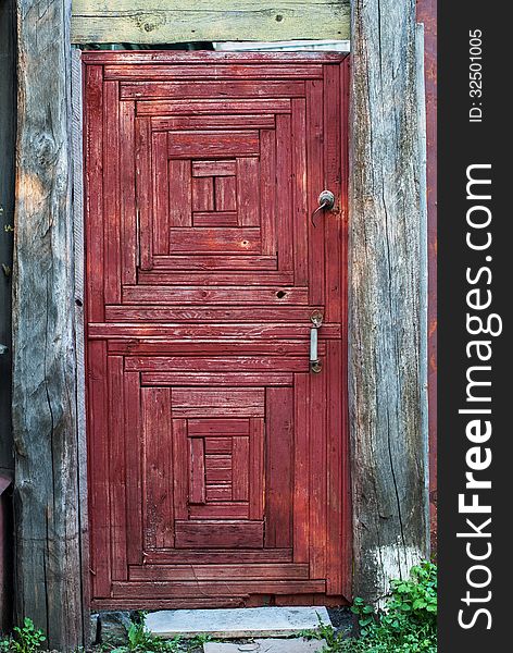 Old Rural Door of red color, retro