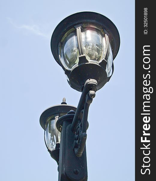 Light poles on street in park