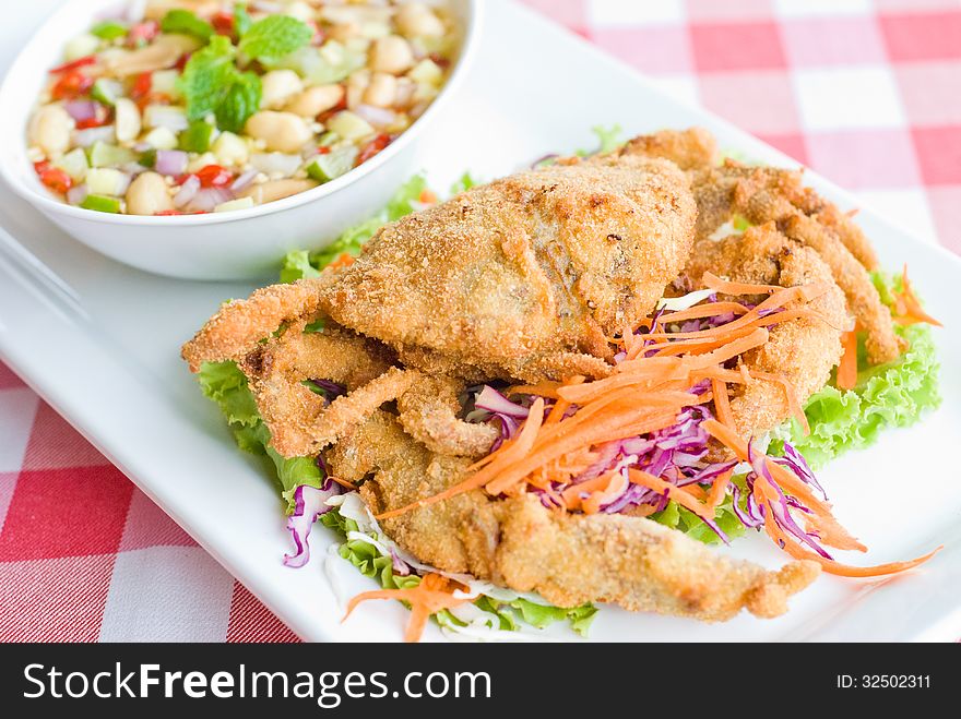 Deep fried crab serve with spicy sauce on white dish