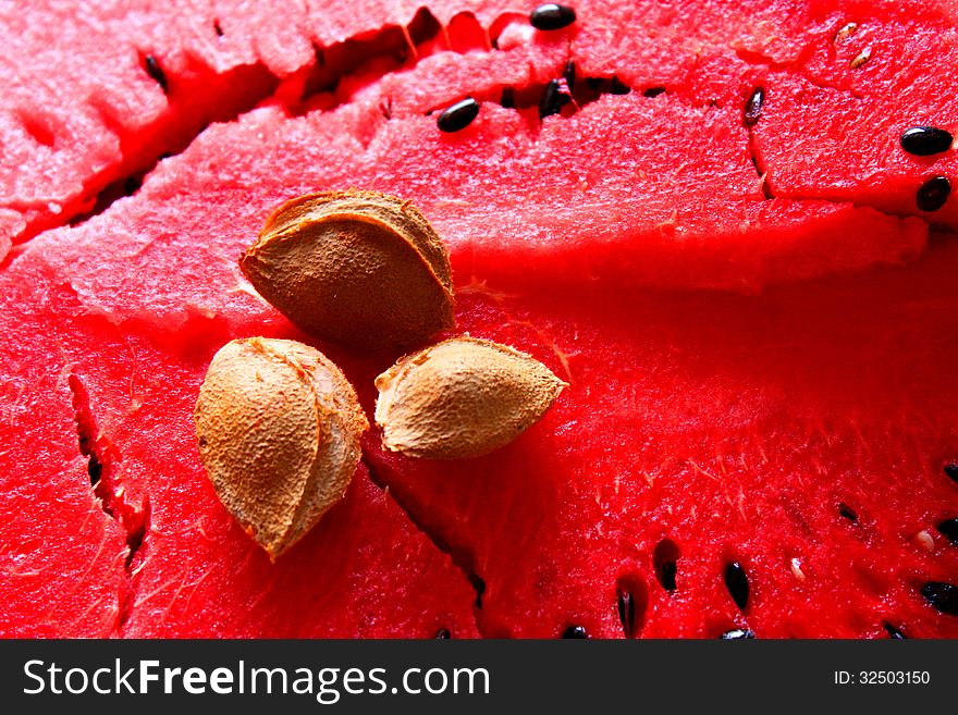 Apricot kernel in the middle of watermelon - core of watermelon. Apricot kernel in the middle of watermelon - core of watermelon.