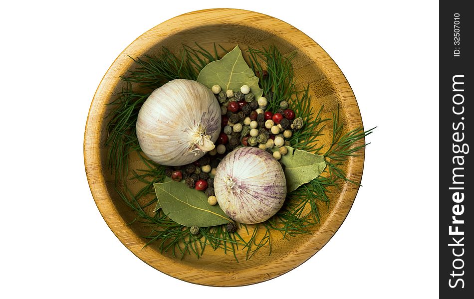 Pepper, garlic and bay leaves in a wooden bowl. Pepper, garlic and bay leaves in a wooden bowl