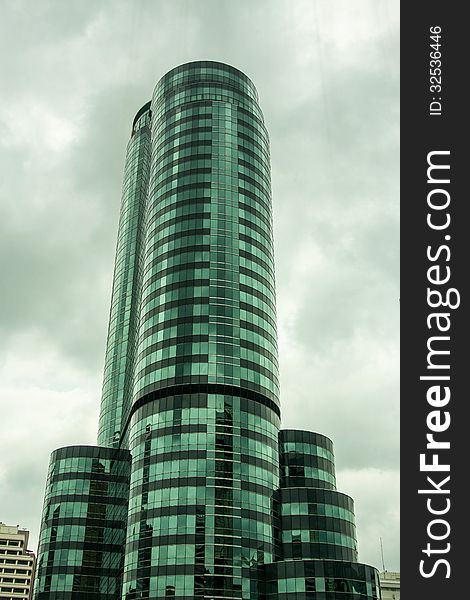 Green mirror building with a dark sky background in bangkok , Thailand.