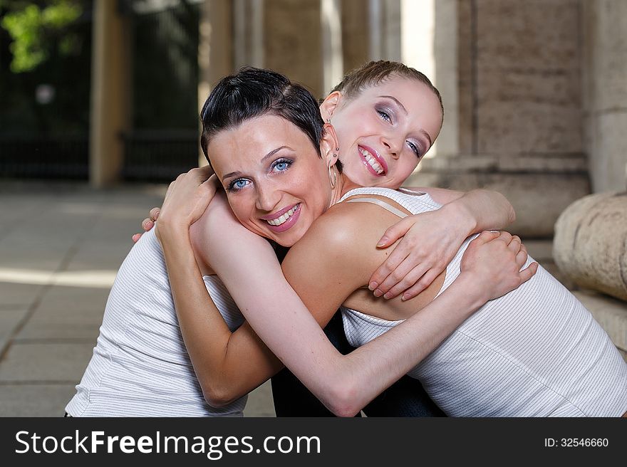 Family, mother and daughter hugging on a walk through the city
