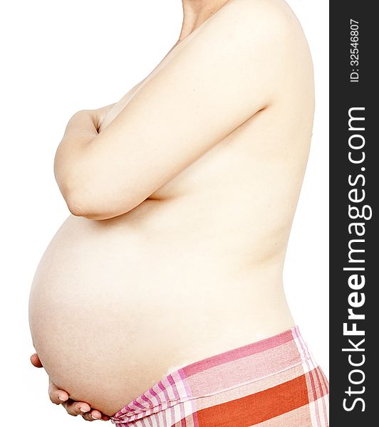 Belly Of Pregnant Woman On White Background