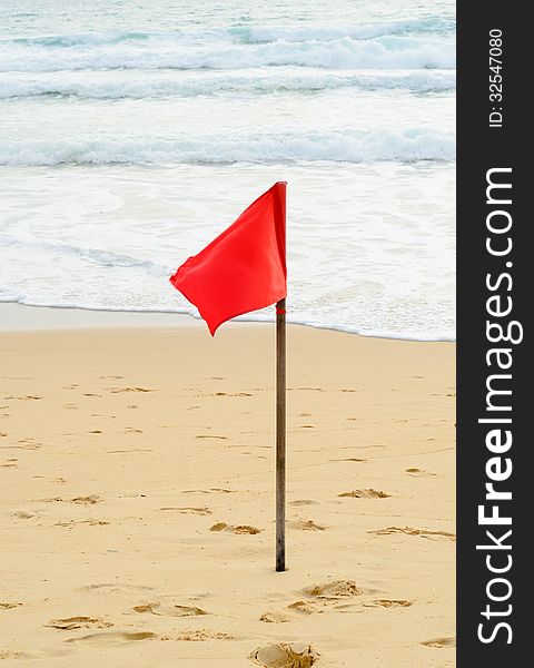 Red warning flag on the beach