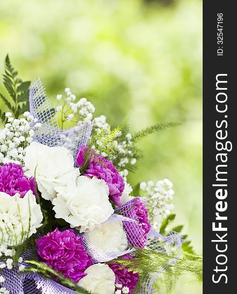 Close up on colorful wedding bouquet made of red and purple flowers