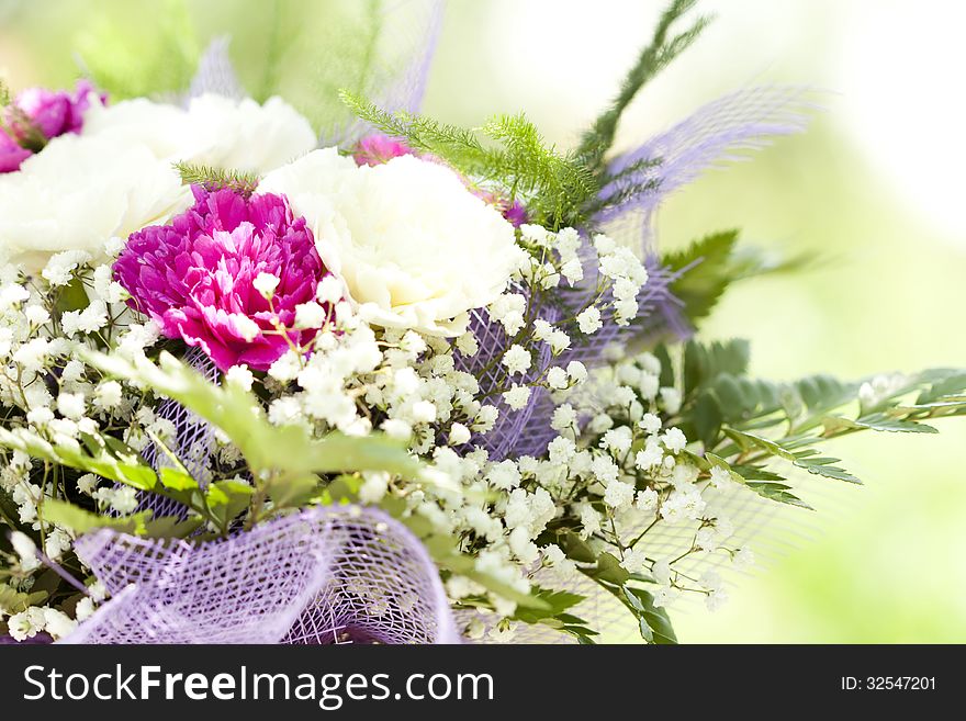 Close up on colorful wedding bouquet made of red and purple flowers