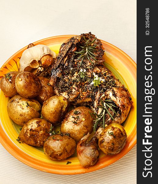 Roasted chicken leg with potatoes and herbs. Roasted chicken leg with potatoes and herbs
