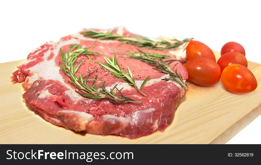 Fresh raw beef on cutting board isolated on white. Fresh raw beef on cutting board isolated on white