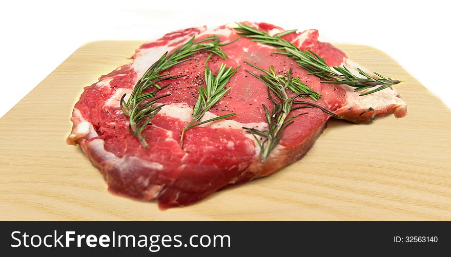 Fresh raw beef on cutting board isolated on white