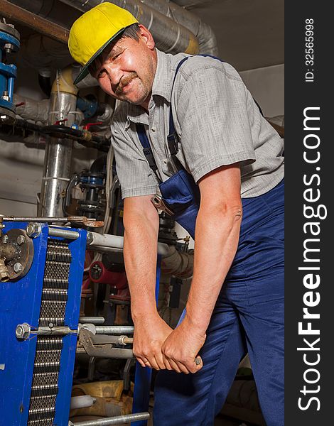 Plumber with pipe wrench works. Plumber with pipe wrench works