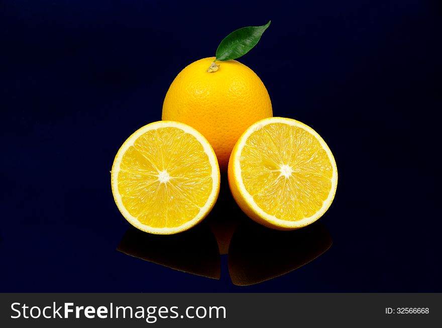 The photograph shows orange fruit placed on a blue background. The photograph shows orange fruit placed on a blue background.