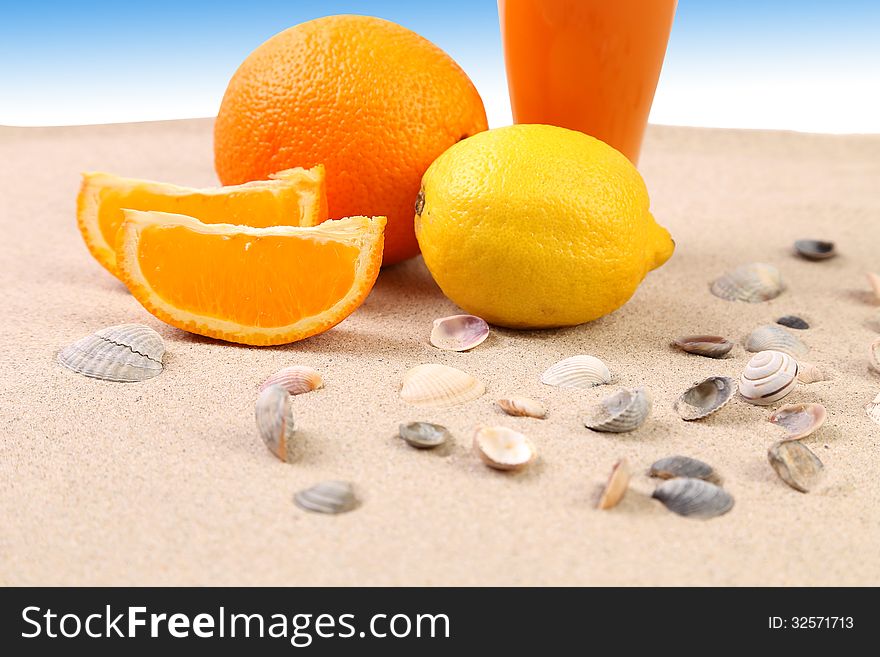 Juice orange lime shells on sand. Blue background.